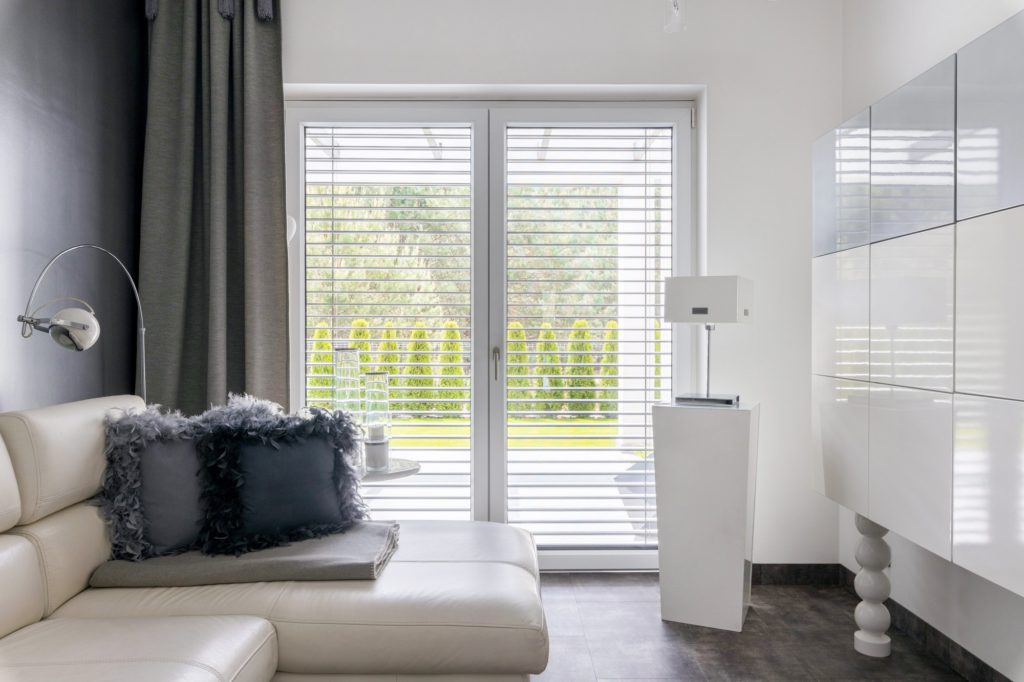 Big window in trendy grey living room interior of suburban house